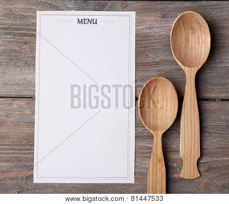 Menu sheet of paper on rustic wooden surface background