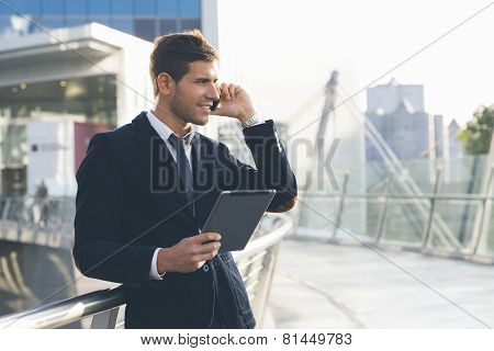 Businessman using a mobile phone and digital tablet