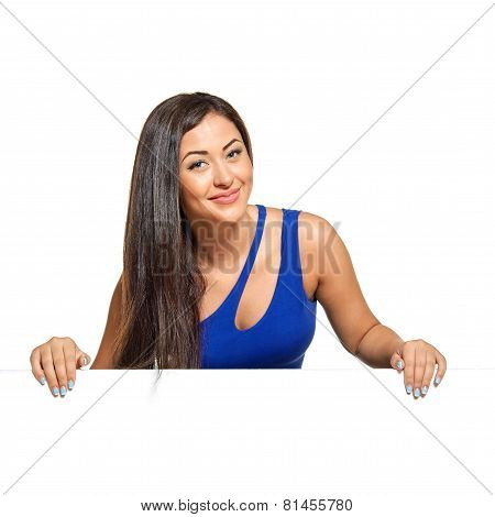 Young pretty woman peeking out from behind the wall