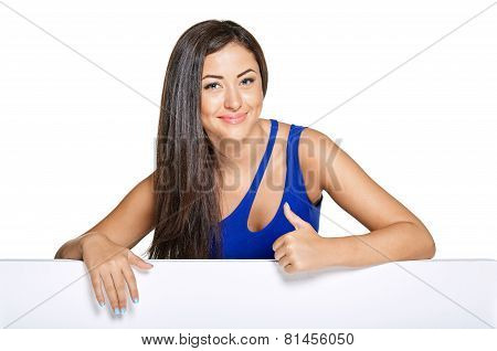 Young pretty woman peeking out from behind the wall