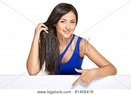 Young pretty woman peeking out from behind the wall