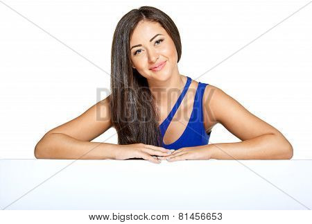 Young pretty woman peeking out from behind the wall