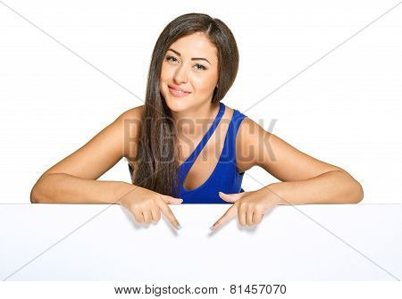 Young pretty woman peeking out from behind the wall