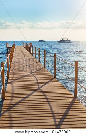 Blue sea and wooden pier