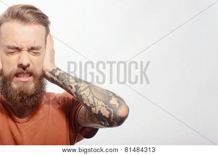 Handsome bearded man with headache