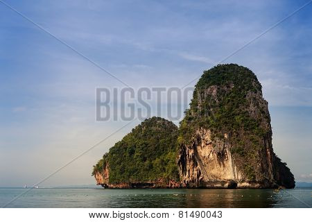 Cliffy Island In Azure Sea Water