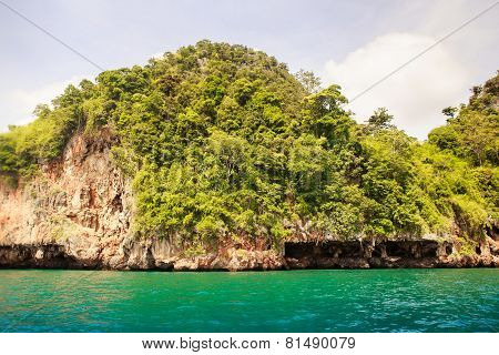 Cliffy Island In Azure Sea Water