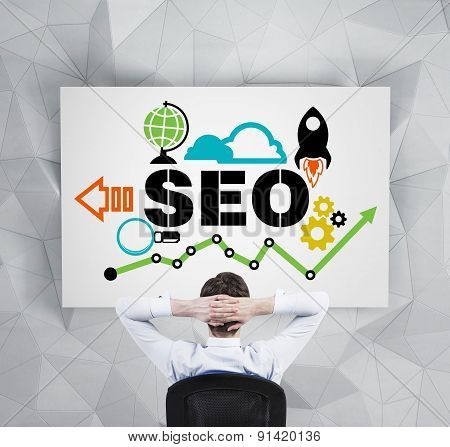 Manager Is Pondering About Implementation Of The 'seo' Optimisation Process. A Person Is Sitting In