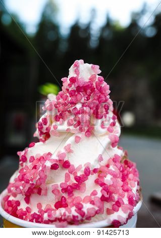 Closeup Of Soft Serve Ice Cream With Fresh Pink Frizzle Outdoors