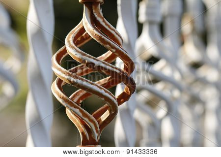 Brown white forged fence inserts close up.