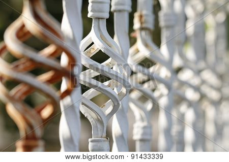 Brown white forged fence inserts close up.