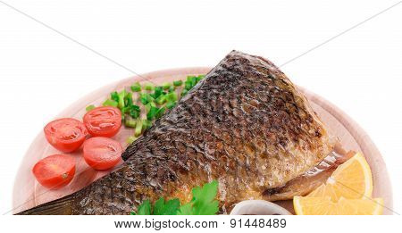 Fried carp tail with lemon and pepper.