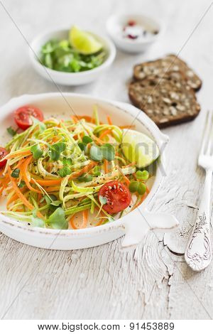 Fresh Salad With Zucchini And Carrots In A Vintage Plate On A Light Surface