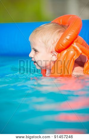 Pretty little boy in swimming pool