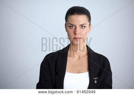 A young woman standing, isolated on graybackground