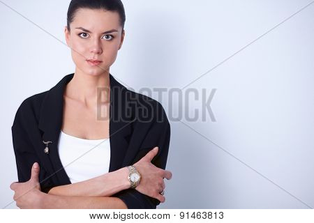 A young woman standing, isolated on graybackground