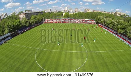 RUSSIA, BOGORODSKOE - MAY 14, 2014: Players attack gate on football field of Spartakovec stadium named by N.P. Starostin during international competition. Aerial view
