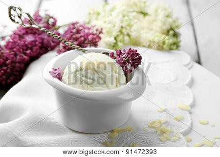 Beautiful composition with tasty ice cream and lilac flowers