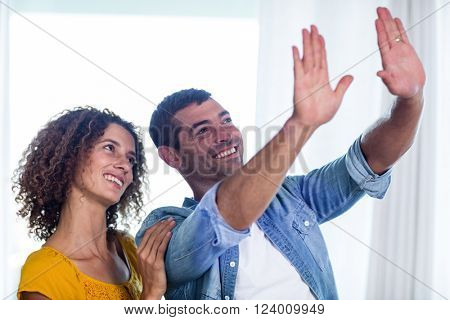 Happy couple planning and gesturing at home