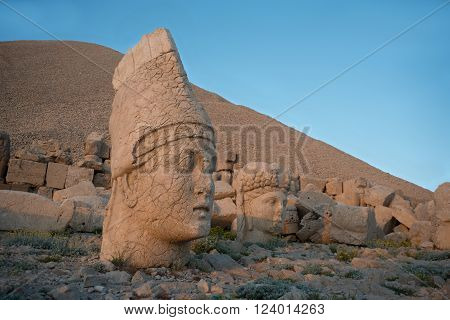 Some of the statues near the peak of Mount Nemrut (Turkey). West Terrace: head of Apollo and head of Goddess of Kommagene (Tyche). Scene in the sunset sun.