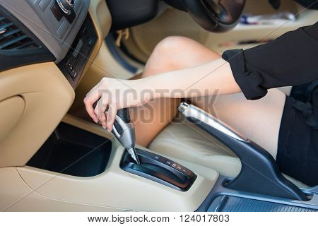 Hand driver shifting gear stick before driving car.
** Note: Visible grain at 100%, best at smaller sizes