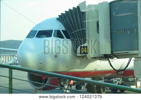 LINATE ITALY - CIRCA JANUARY 2016: baircraft parked by a tunnel bridge ready for boarding or unboarding at the airport of Milano Linate