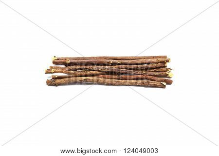 Licorice root lying on a white background