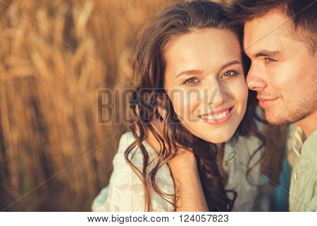 Young couple in love outdoor.Stunning sensual outdoor portrait of young stylish fashion couple posing in summer in field