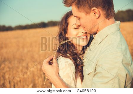 Young couple in love outdoor.Stunning sensual outdoor portrait of young stylish fashion couple posing in summer in field