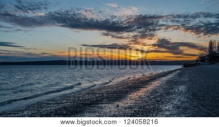 The sun sets on the Puget Sound at Three Tree Point in Burien, Washington.