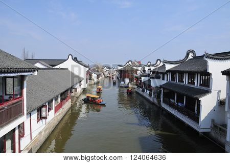 Shanghai, China.  February 8, 2016.  Chinese visitors during Spring Festival on tourist boats on the water canals of Zhaojialou town on a sunny day in Shanghai China.