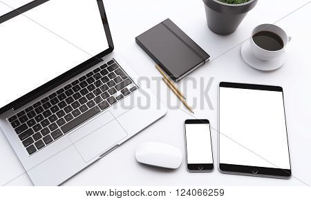 Laptop smartphone and tablet with white screens coffee mouse datebook and plant on table. Concept of work. Mock up. 3D rendering