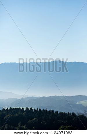 impressive hilly ground with hills , sky and mist