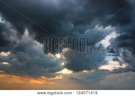heavy cumulus before storm over amber horizon