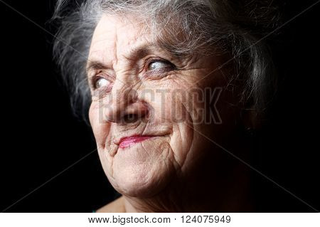 Thougtful granny face on a black background