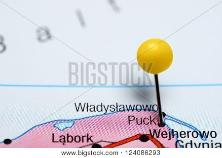 Photo of pinned Puck on a map of Poland. May be used as illustration for traveling theme.