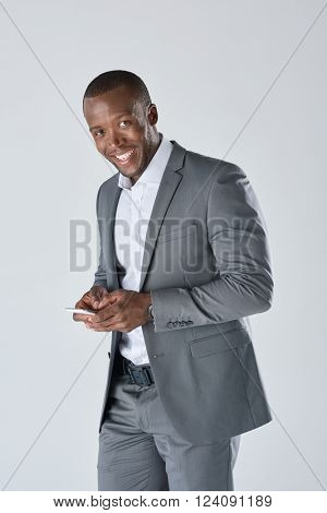 Black professional businessman in suit on his smartphone in studio