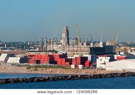Montevideo, Uruguay - December 15, 2012: Montevideo cityscape from port district - Containers at the port, on the ship in the foreground at Montevideo, Uruguay.