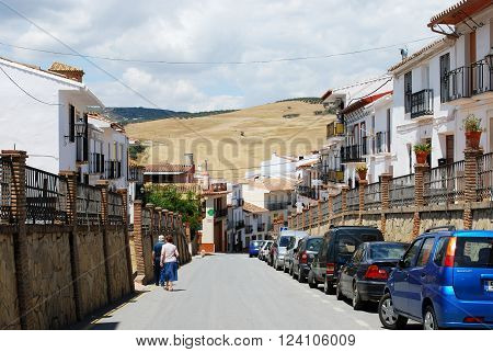 RIO GORDO, SPAIN - JUNE 1, 2008 - View along a town street towards wheat fields on the mountains Rio Gordo Malaga Province Andalusia Spain Western Europe, June 1, 2008.