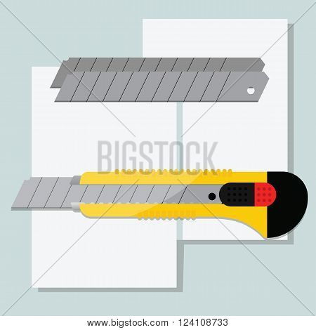 Yellow stationery knife and blade set against the background of the paper sheets