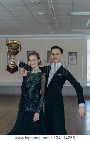 Professional dancers dancing in ballroom. Young couple