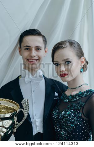 Professional dancers dancing in ballroom. Young couple