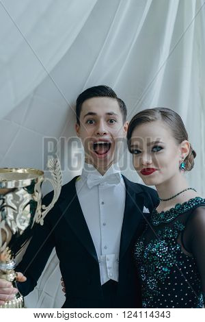 Professional dancers dancing in ballroom. Young couple
