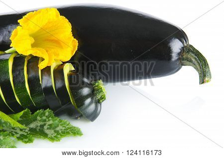 Courgette cut into slices and leaves on white