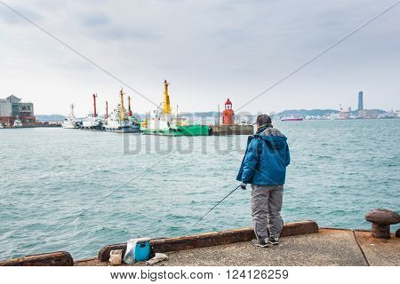 Japanese fisherman trying to fishing at mojiko port fukuoka japan.
