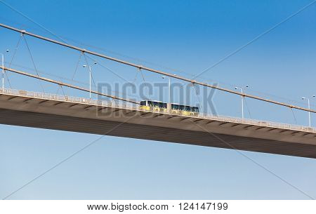 bus on the bridge on Bosphorus connecting the european waterside of Istanbul with the asian waterside on background of blue sky