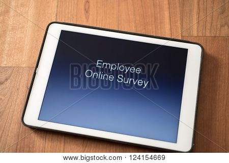 tablet on table with online employee survey