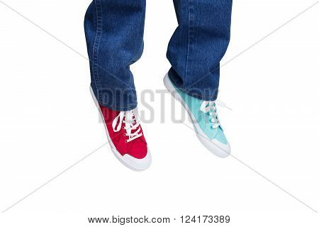 wearing jeans and different sneakers on legs