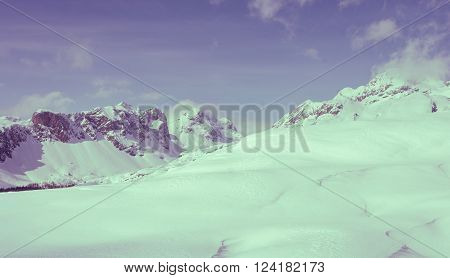 Winter panorama with snow covered slopes and dramatic sky. Komna, Slovenia.
