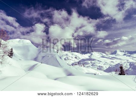 Winter panorama with snow covered slopes and dramatic sky. Komna, Slovenia.